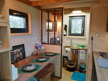 The dining area with a view of the bathroom