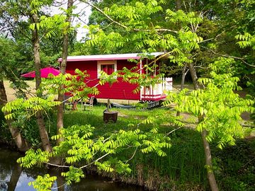 Red gypsy cravan by the river
