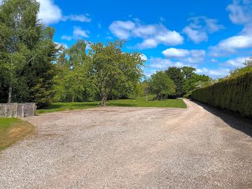 Gravel hardstanding and grass pitches beyond