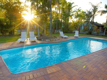 Swimming pool with sun loungers