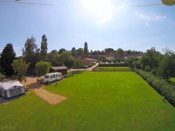 Aerial view of the campsite with the pub in the background