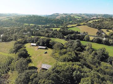 Site surrounded by hills and woodland