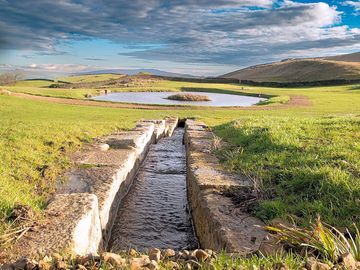 Stone waterfall leading to a lake