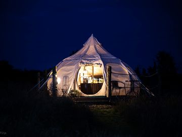 Luxury glamping bell tents, furnished with a comfortable double bed and various cosy amenities