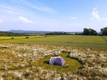 A wider view overlooking the site towards the Malvern's