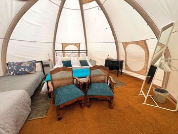 Bell tent showing kingsize and single bed