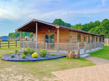 The log cabin with private parking for up to 2 cars with covered veranda.