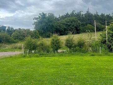 Well-Maintained Pitch – Clean, grassy space suitable for caravans or motorhomes.