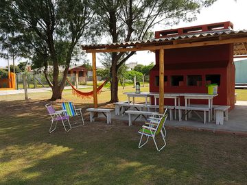 Outdoor kitchen with grills, washbasin, stove and fridge