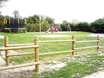 Play area with a trampoline, swing, slides and many more