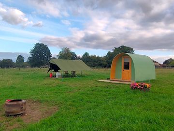 Pod with tent pitch in the background