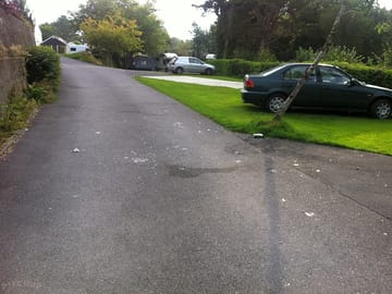 Broken glass on road along with bottles and cans from late night party (added by Rover1 15 Sep 2014)