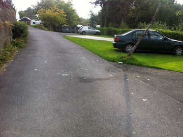 Broken glass on road along with bottles and cans from late night party