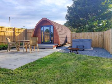 Private garden area with hot tub, seating and barbecue