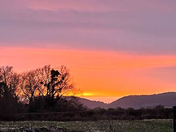 Sunset over the Malvern Hills from the site (added by manager 02 May 2024)
