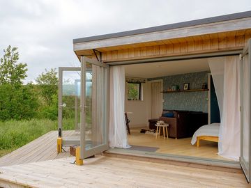 Deck and open doors looking into Tawny's living area