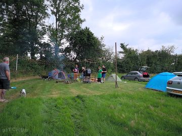 A small group happily pitched up on the field