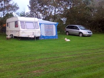 Our family caravan, awning, car and dog, westie, with loads of space left