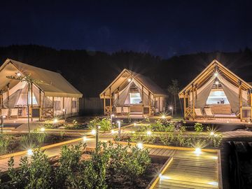 Large safari tents by night