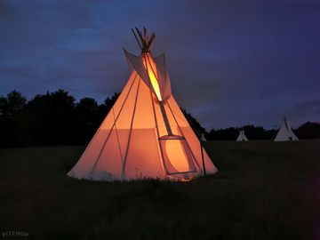 Tipi lit up at night