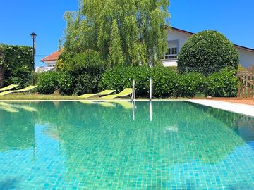Swimming pool and sun loungers