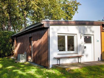 A private entrance with garden and parking space for the car.