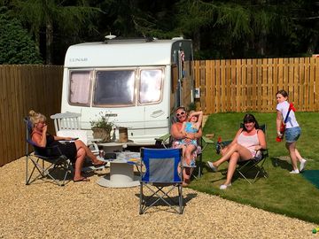 Family sat around their touring pitch