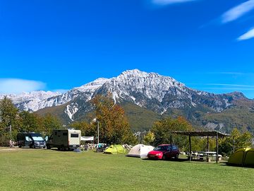 Grass pitch with campervans and tents