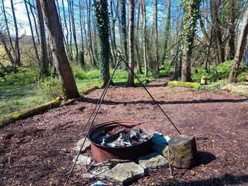 Large firepit with a cooking tripod