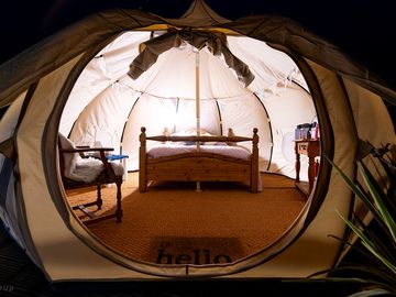 Luxury glamping bell tents, furnished with a comfortable double bed and various cosy amenities