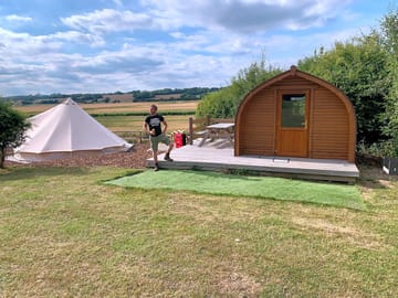 Husband enjoying looking at the cabins and bell tents.