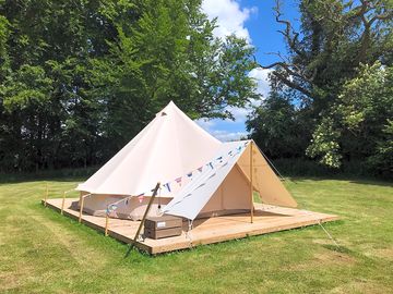 Bell tent on a wooden base