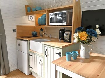 Kitchenette with an induction hob, fridge-freezer and kettle