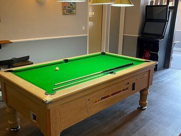 Pool table and darts area inside the pub