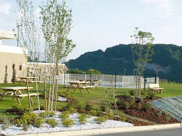 The barbecue area equipped with picnic tables