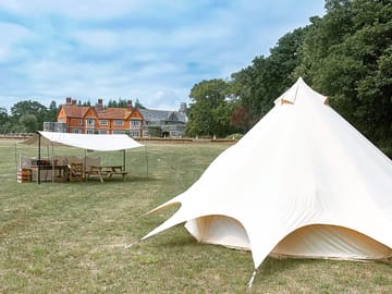 Where the bell tent is sited (2021) with views of Trigon House and the camping field