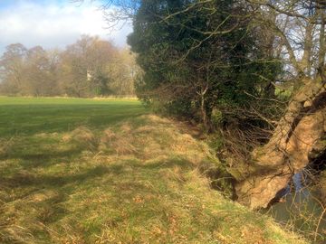 A stream runs alongside the campsite