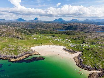 Achmelvich beach backed by a mountain view