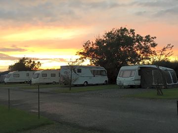 Our hard-standing touring pitches at sunset