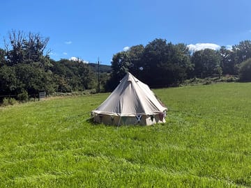 Customer with their bell tent in the camping field