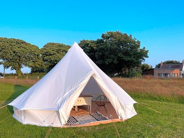 Bell tent with double bed, storage and seating