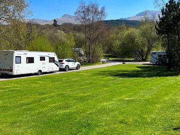 Grass and hardstanding pitches with mountain views