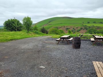 Hardstanding with picnic tables by the cider barn