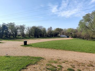 The pitches are backed by trees