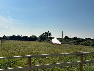 Bell tent located in the meadow camping field