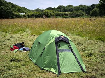 Grass pitch in a meadow shard facilities include shower toilet, field kitchen hot tub, fire pits
