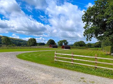 Grassy pitches and glamping pods