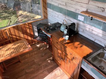 Kitchenette with coffee machine provided, gas hob and kettle.