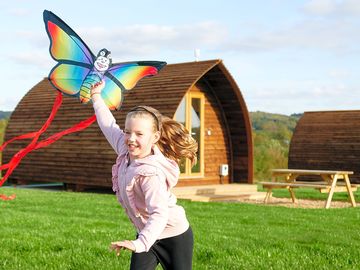 Guest flying a kite in front of the wigwam