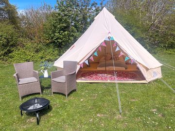 Superior bell tent with outdoor chairs and firepit